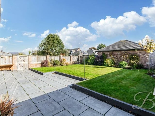 The spacious and enclosed rear garden has been stunningly landscaped to provide a granite slab patio area, a manicured lawn, trees and shrubs. It's a lovely area to sit back and relax on a summer's day while the kids play.