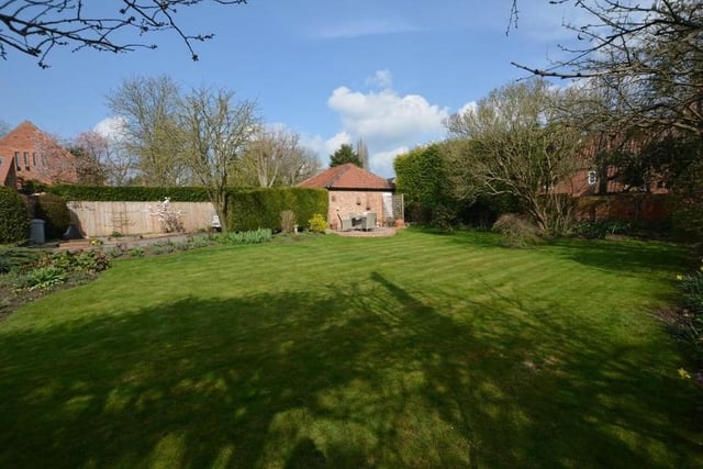 There is a lovely garden at the £950,000 property. A formal lawn is surrounded by mature trees, beds and borders made up of flowers and shrubs,  and also vegetable or fruit beds. External floodlights and a log store are added bonuses.