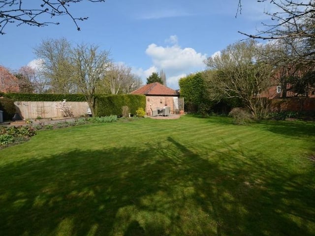 There is a lovely garden at the £950,000 property. A formal lawn is surrounded by mature trees, beds and borders made up of flowers and shrubs, and also vegetable or fruit beds. External floodlights and a log store are added bonuses.