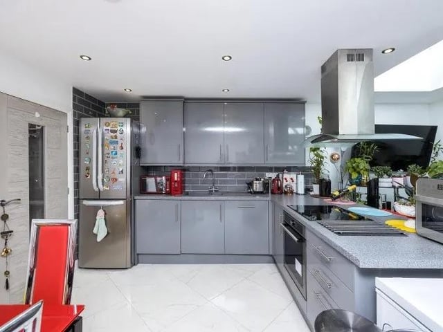 Our photo tour of the Percy Street property begins in the open-plan kitchen/diner and living area. This is the modern kitchen, which has a range of high-gloss wall and base units, plus integrated appliances.