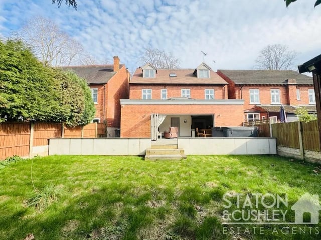 To the rear there is a well established garden and impressive patio which houses the hot tub as well as a lined area and shed for additional storage