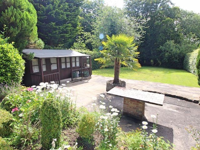 The garden boasts a summerhouse and workshop/garden shed.
