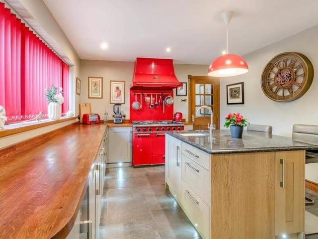Integrated appliances in the kitchen include a microwave, a coffee machine and a fridge. Other assets include a tiled floor, ceiling spotlights, vertical radiators, kickboard spotlights and French doors to the conservatory.