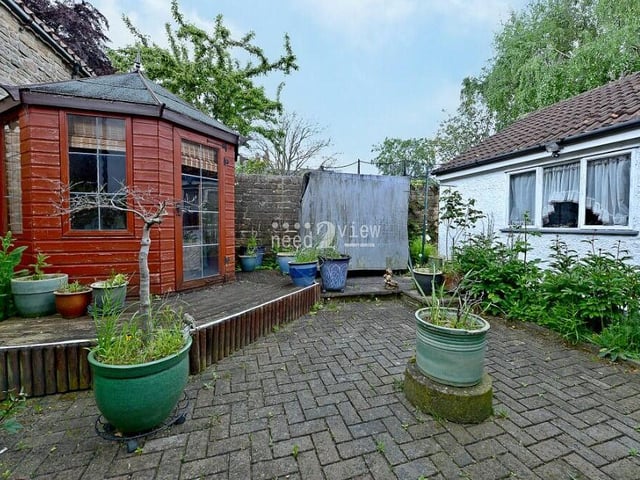 There's so much to look at outside Cosy Cottage, so let's quickly begin in the easy-to-maintain rear garden. It is fully block-paved, with a charismatic summer house on some raised decking.
