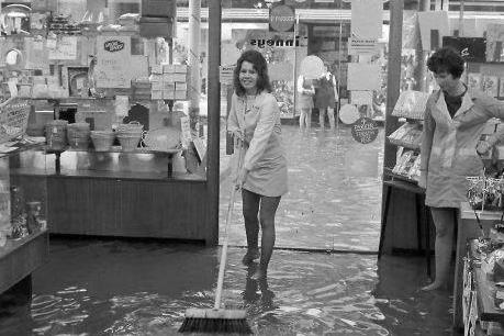 Shop workers attempt to get rid of the excess water back in 1973.