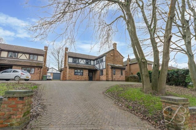 Let's step outside now, and here is the lengthy, well-maintained driveway, off Kings Lodge Drive, that leads to the £450,000 property. It provides ideal off-street parking space.