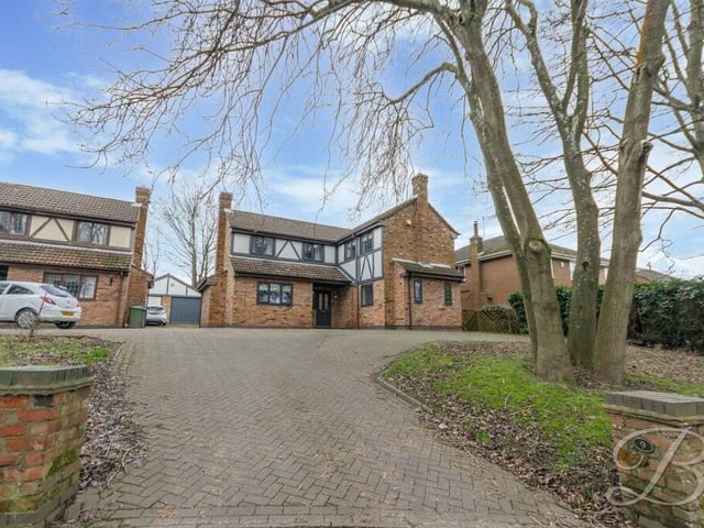 Let's step outside now, and here is the lengthy, well-maintained driveway, off Kings Lodge Drive, that leads to the £450,000 property. It provides ideal off-street parking space.