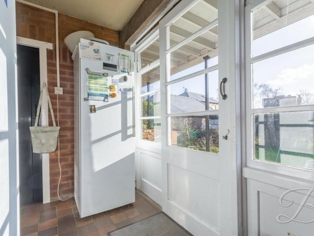 Next to the kitchen is this handy utility room, where there is space for further appliances. Sliding doors lead to the back garden.