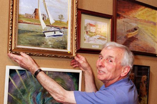 Edgar Halstead hanging one of his paintings up at an art fair in St Oswolds church, Kirk Sandall, 1999.