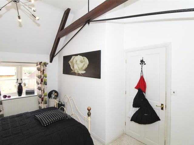 The vaulted and beamed ceiling is a distinctive feature of bedroom number two.