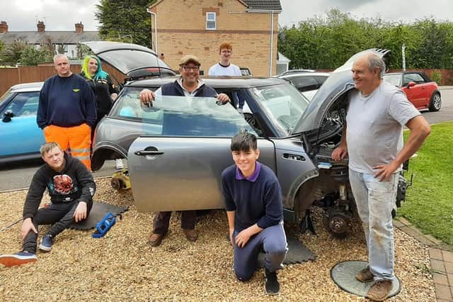 Mini enthusiasts working on the car at the Huthwaite home of Chris Miller.