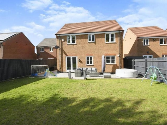 A couple of exterior shots to complete our tour, beginning with this view from the rear. The back garden consists of a large lawn and a patio area that would be ideal for entertaining guests in the summer.