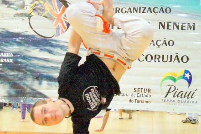Aaron displays one of his many capoeira movements,