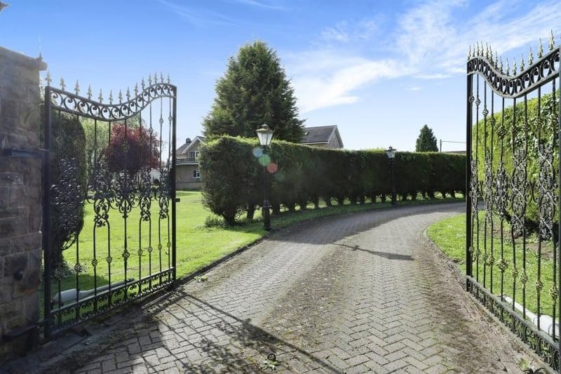 Majestic electric gates, which are served by an intercom system, open on to a large, private driveway that leads to all three properties. The winding driveway is lined by Victorian street lanterns that work on sensors, and also by tall conifer trees.
