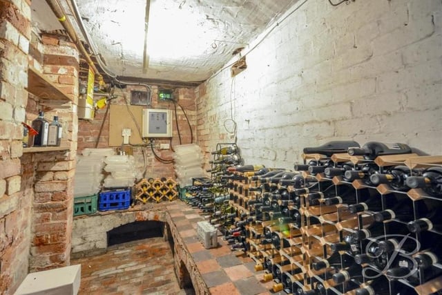 The ground floor provides access to the cellar, which looked particularly well stocked at the time this photo was taken! It boasts ample storage space and a door leading outside.