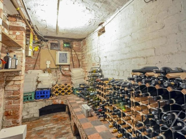 The ground floor provides access to the cellar, which looked particularly well stocked at the time this photo was taken! It boasts ample storage space and a door leading outside.