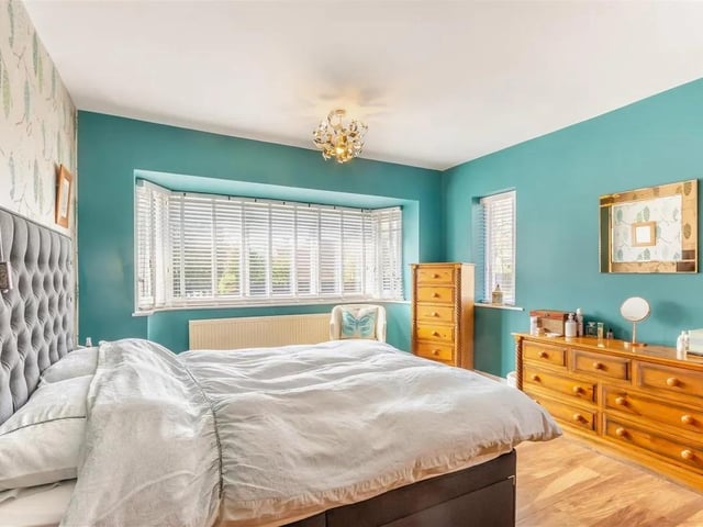 A large, dual aspect double bedroom with laminate floor, radiator, two double glazed windows to the side elevation and large double glazed bay window to the front elevation.