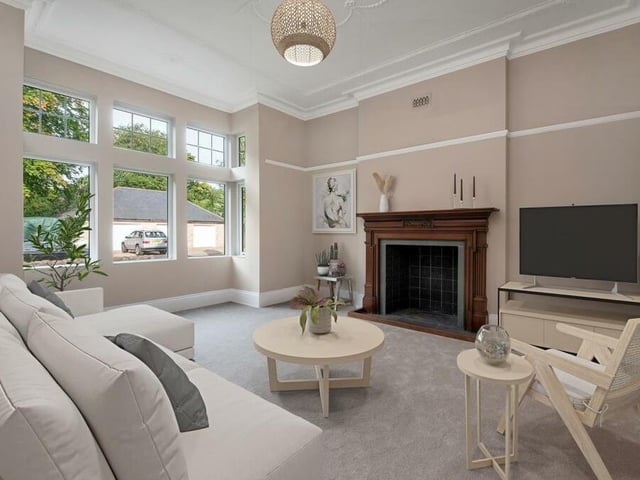 This lovely lounge is one of two large reception rooms on the ground floor of Abbeydale. Notably, it features a fireplace with open flue, tiled hearth and wood surround, while a large bay window overlooks the front of the property.