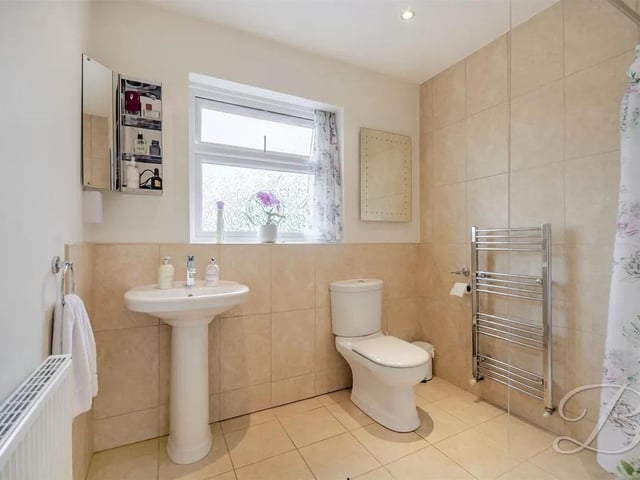 The shower room is complete with a three piece suite including a walk in shower, low flush WC and a hand wash basin. With a window to the rear elevation.