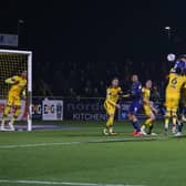 Oli Hawkins wins the header during tonight's Sky Bet League Two match at Sutton United. Photo by Chris Holloway/The Bigger Picture.media