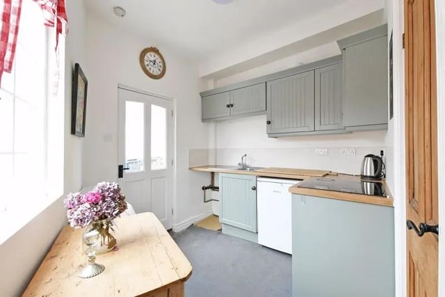 The kitchen has natural light from two sides, access onto a rear flagged terrace, and an open plan design into a deep under-stair recess, which as a hatch in the floor, providing access to the basement.
