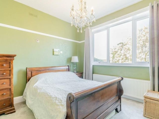 This bedroom conveys a touch of class. It features a dado rail and overlooks the front of the property.