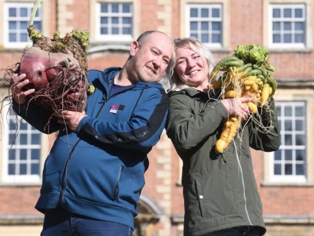 Mansfield's Chris Marriot and his partner Agata Soltysiak with their 'Heaviest Carrot' and 'Heaviest Beetroot' at the 2024 Harrogate Autumn Flower Show.