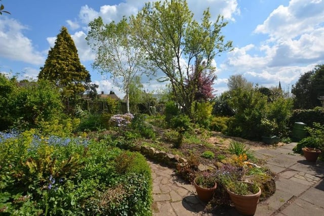The back garden also features a patio and pathway. It's a lovely place to be in the sunshine.