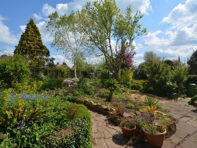 The back garden also features a patio and pathway. It's a lovely place to be in the sunshine.