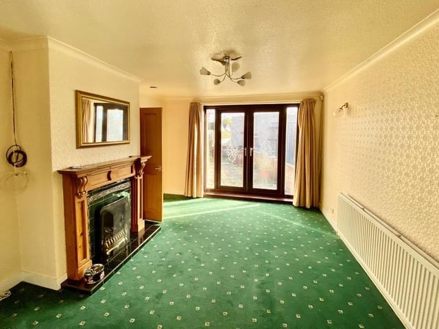 The lounge is bright, thanks largely to uPVC double-glazed French doors that lead to the back garden.