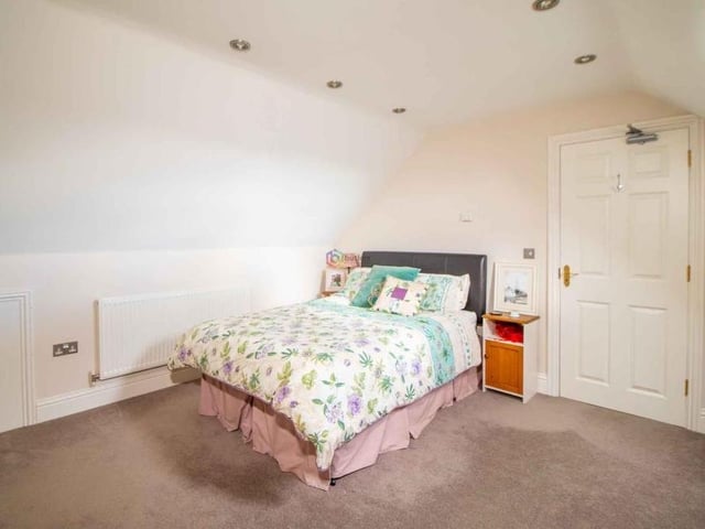 The next bedroom is the first of two attic rooms. An excellent size, it has a Velux window, built-in wardrobe and access to en suite facilities.