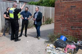 Coun Samantha Deakin, Antonio Taylor, council community safety manager,  Coun David Hennigan and Richard Townsley, community protection team member, witness first hand fly-tipping in one of the alleys earmarked for closure