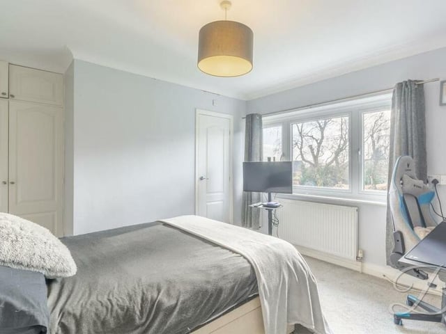 Bedroom number two also overlooks the rear garden and has its own en suite facilities. There is a cupboard for additional storage and space for a desk, while the floor is carpeted.
