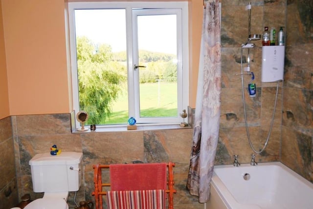 The bathroom offers more countryside views. It also features a heated towel-rail and even its own fireplace.
