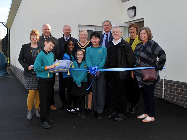 Chairman of Nottingham County Council, Coun Yvonne Woodhead joins members of the school council, headteacher Samantha Bradbury, Coun John Peck, govenors and invited guests to cut the ribbon at the opening of the new extension.