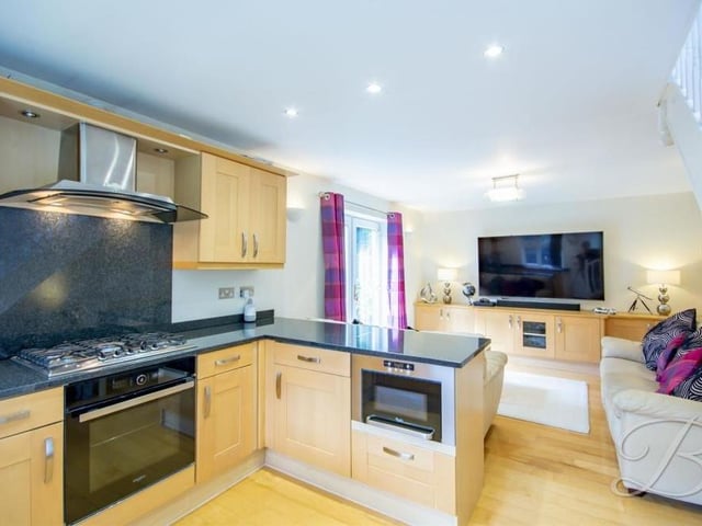 The ground floor of the modern annexe is taken up by an open-plan kitchen and lounge or living room. In the kitchen, there is an integrated oven and hob, plus space for all essential appliances. A range of matching units and cabinets comes complete with a granite worktop over, inset sink and drainer.