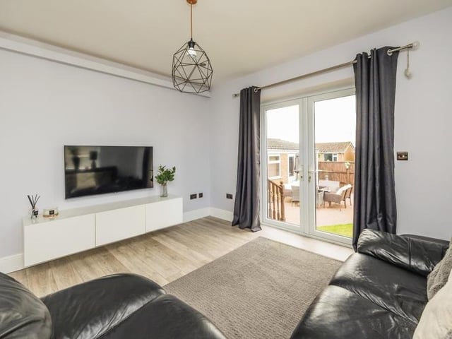 The large double doors in the living room open out on to the garden. An ideal arrangement for the summer.