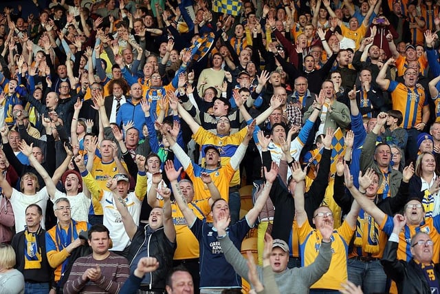 Mansfield Town fans celebrate after winning the Blue Square Bet Premier and securing promotion back to the Football League.