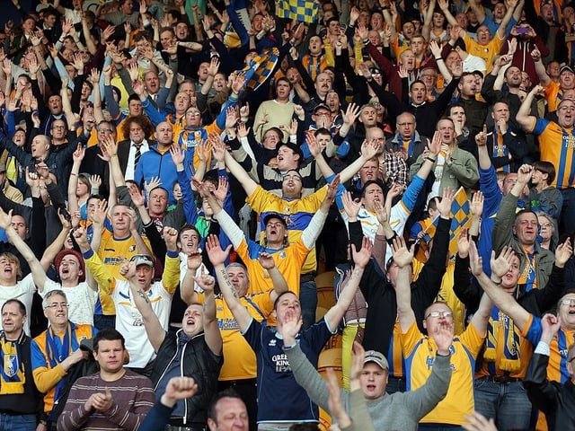 Mansfield Town fans celebrate after winning the Blue Square Bet Premier and securing promotion back to the Football League.