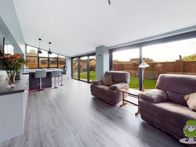 Not only are there expansive windows in the kitchen/living area but also new, sliding picture-frame doors that give access to the garden at the back of the house.