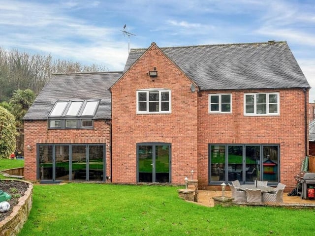 Here is a view from the back of the house, showing all the ground-floor doors that open out on the garden and a charming patio area.