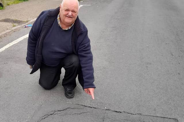 Mansfield councillor Stephen Garner by the sink hole that has appeared on Hall Street in the town. He is urging drivers to "be aware".