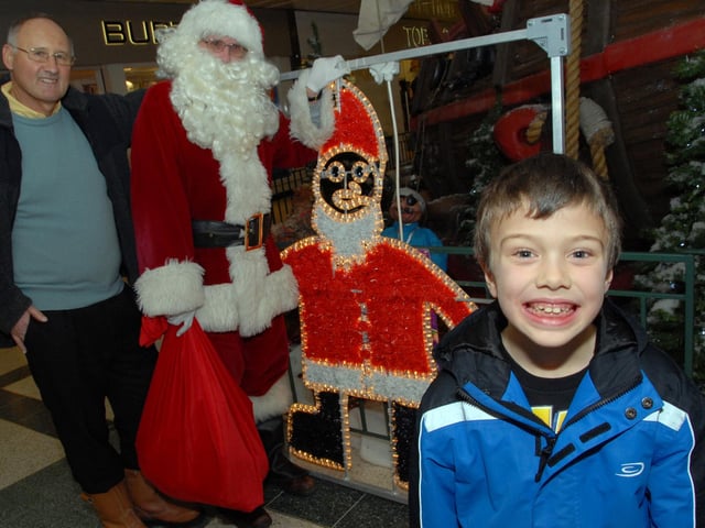 Mansfield's Owen Cartwright, right, was joined by Santa and Chairman of The Mansfield Christmas Lights Committee Bill Taylor, left,  for the unveiling of his winning design at Mansfield's Four Seasons Shopping Centre in 2010.