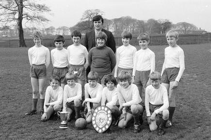 The 1971 Berry Hill Junior School football team show off their trophies.