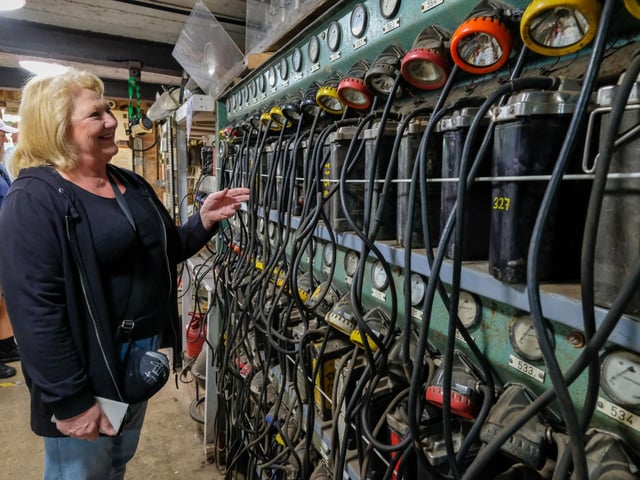 Sally Kirk looks over the old miner's lamps on display.