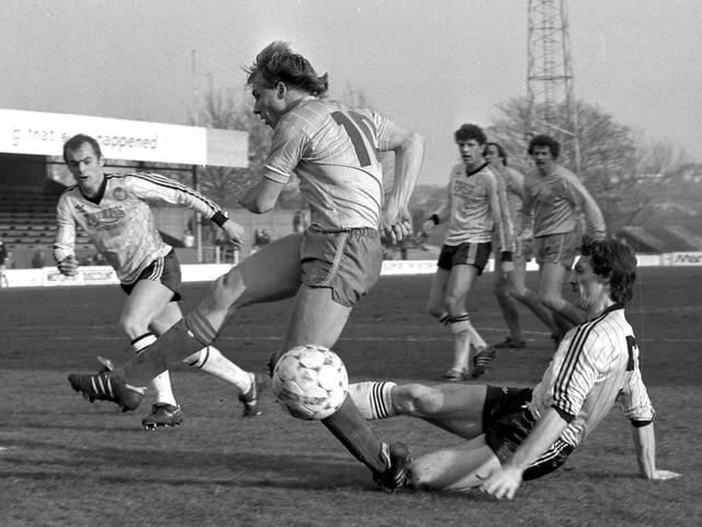 Dave Caldwell is tackled during the visit of Hereford United