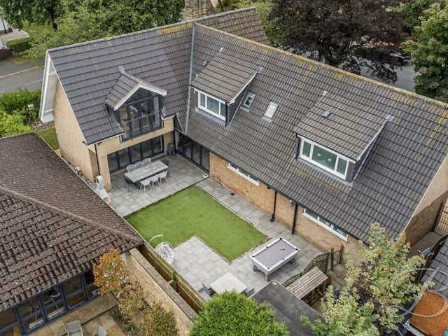 This drone shot gives a bird's eye view of the Mansfield property and its rear garden.