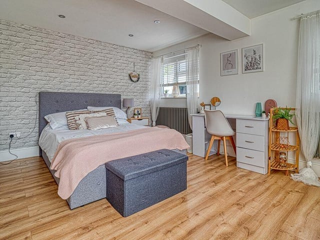 This bedroom sits at the front of the £600,000-plus property, having previously been the garage. It was tastefully converted in 2022, complete with a walk-in wardrobe and laminate flooring.
