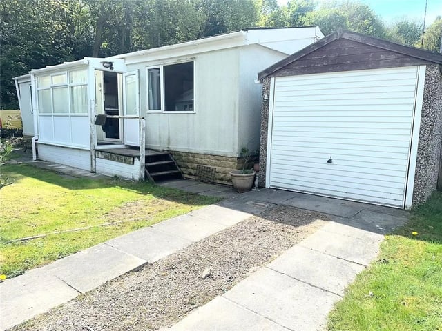 Bungalow alternative. offstreet parking and A garage! . Open plan lounge dining room . over 50's. A two bedroom park home which is situated on a corner plot benefiting from off-street parking and a garage! Internally there is an entrance porch, spacious kitchen, an open plan lounge dining room, two good sized bedrooms and a shower room. There are lawned gardens to the front and side which is surrounded by mature shrubs and tree with off-street parking and a garage. To the other side there is a paved area. On this site, you will be buying the home but not the land. The pitch remains in the ownership of the site owner who is responsible for maintaining the site. The fee for ground rent as of April 1st 2025 will be £243 per calendar month.