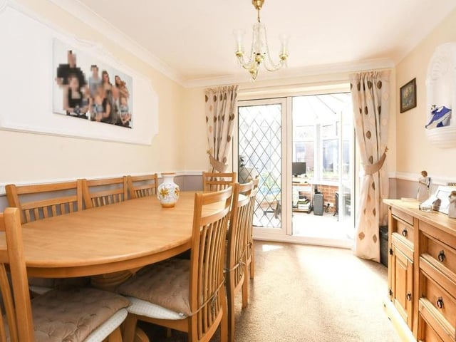 Double doors in the living room open the way into this dining room, which has plenty of space for a sizeable table and chairs. More doors lead to the conservatory at the back of the property.
